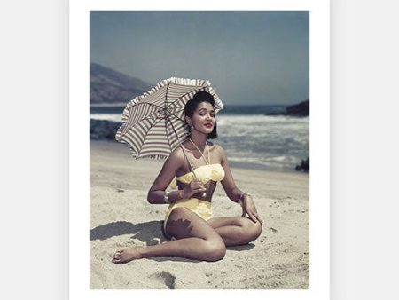 Woman on Beach Holding Umbrella on Sale