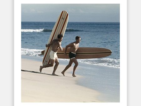 Young men running on beach with surfboard Discount